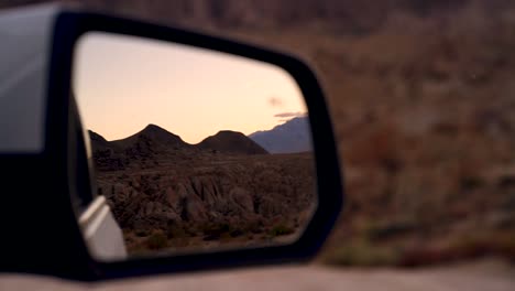 Desert-red-rocks-mountain-landscape-view-of-reflection-on-a-car-mirror