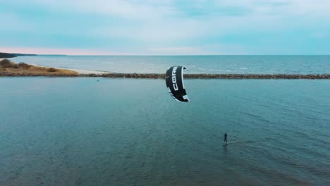 Engure,-Latvia,-23-May-2022:-Aerial-Drone-View-of-a-Corekites-Kitesurfers-Hydrofoiling-in-Engure-Port-at-in-Baltic-Sea