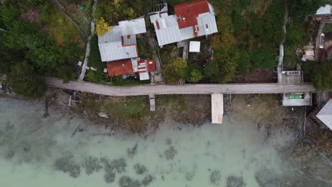 Drone-footage-of-a-walkcat-in-Caleta-Tortel,-a-village-without-streets-in-South-America