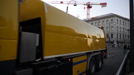 Yellow-maintenance-truck-passing-for-maintaining-tram-in-Gothenburg,-Sweden,-pan