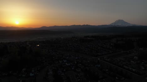 Panning-aerial-of-the-sunrise-and-a-mountain-on-the-horizon
