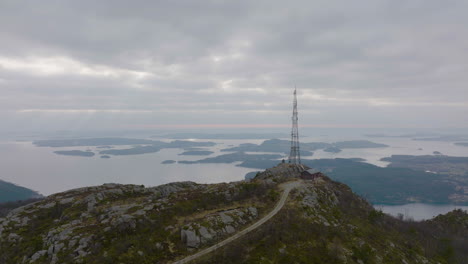 Phone-Mast-Tower-On-Top-Of-Mountain-With-Island-And-Calm-Waters-In-The-Background