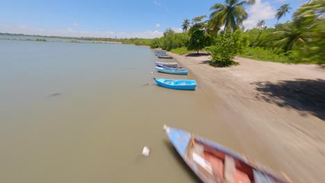 Aerial-flyover-parking-small-boats-at-Nueva-Romana-Beach-during-sunny-day-on-Dominican-Republic