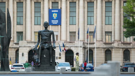 Time-lapse-of-historic-statue-in-central-bucharest-with-a-kid-playing-around-and-traffic-trails-in-foreground