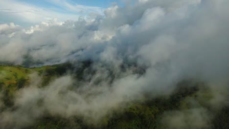 Low-tropical-fog-hangs-across-lush-fertile-rainforest-mountains,-Guanacaste,-Costa-Rica,-aerial