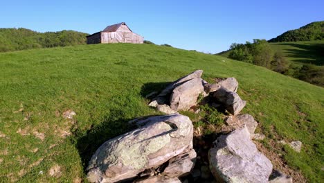 old-barn-with-boulders-in-foreground-aerial-near-bethel-nc,-near-boone-and-blowing-rock-nc,-north-carolina
