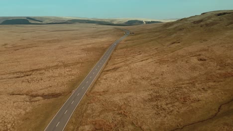 Abstract-aerial-view-of-Empty-country-road-between-brown-dried-up-field
