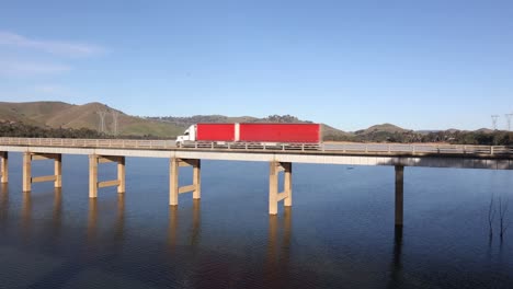 A-big-semi-trailor-truck-crossing-a-bridge-over-lake-Eildon-in-Australia