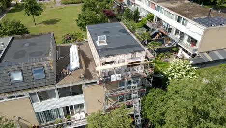 Jib-up-of-rooftop-under-construction-and-renovation-in-a-green-suburban-neighborhood