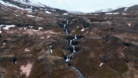 Retroceso-Sobre-Una-Serie-De-Cascadas-En-Klifbrekkufossar-En-El-Río-Mjoifjordur,-Este-De-Islandia