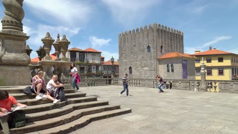 People-Sitting-on-Pillory-of-Porto-on-Sunny-Bright-Spring-Day
