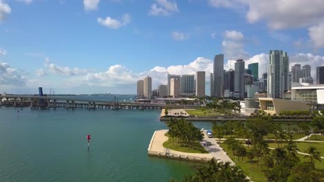 Aerial-view-over-the-coast,-revealing-the-FTX-Arena,-in-sunny-Miami,-USA---rising,-pan,-drone-shot