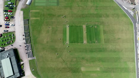 4K-video-flying-over-a-great-setting-for-a-village-cricket-match-in-Yorkshire,-UK
