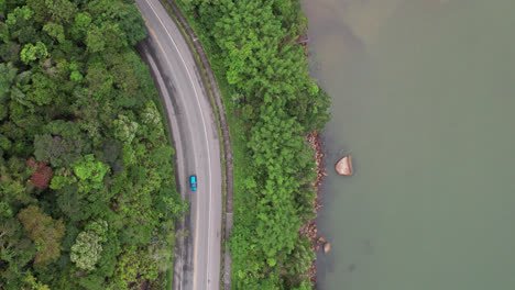 Aerial-birdseye-flying-over-riverside-road,-Brazil