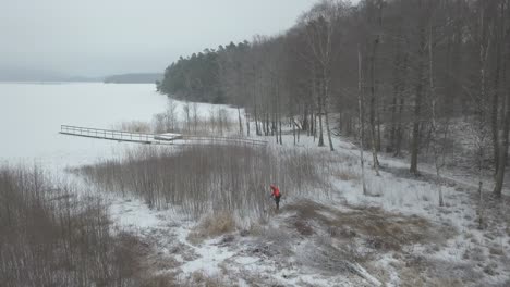 A-forest-worker-next-to-a-winter-lake