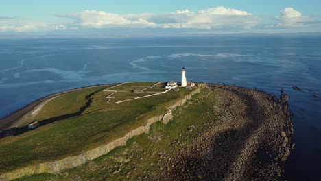Aerial-view-of-Pladda-Lighthouse-on-the-Isle-of-Arran-on-a-sunny-day,-Scotland