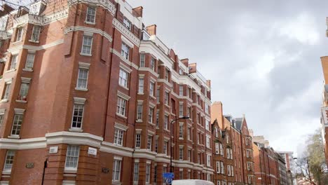 Tilt-down-shot-of-a-luxurious-London-street-with-red-brick-buildings-in-St-Pancras-area