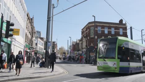 London-tram-passing-through-intersection-in-croydon-old-town-follow
