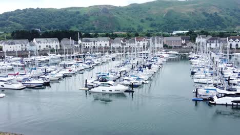Luxury-yachts-and-sailboats-parked-on-misty-mountain-range-retirement-village-marina-slow-right-orbit