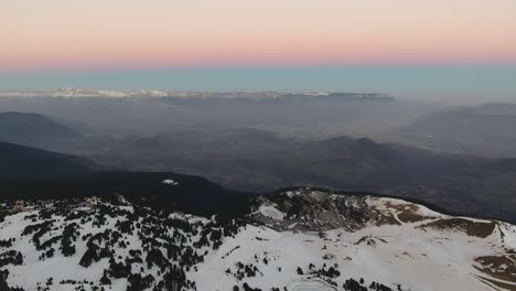 Foggy-Alpine-landscape-at-Chamrousse-France-during-morning-sunrise-showing-pastel-colors,-Aerial-slow-pan-left-shot