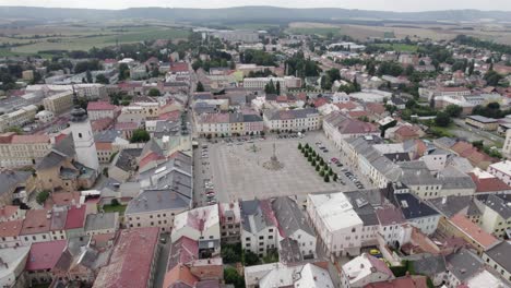Flight-of-a-drone-to-the-square-in-the-town-of-Moravska-Trebova-in-the-middle-of-summer-over-historic-buildings,-Czech-Republic