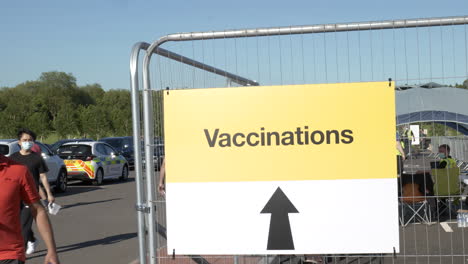 People-wearing-masks-walking-into-a-COVID-19-vaccination-medical-centre