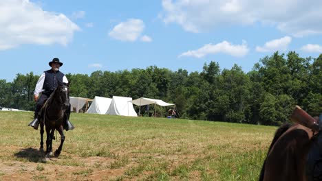 Union-Civil-War-officers,-at-Gettysburg,-ride-by-on-horses-with-camps-in-the-background