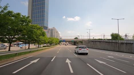 Seoul-traffic---Driver's-POV-on-multilane-Gangbyeonbuk-ro-expressway-road-daytime-in-summer