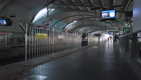 Pov-Zum-Bahnsteig-Der-Skytrain-Station,-Während-Passagiere-Auf-Den-Herannahenden-Zug-Warten-Und-In-Den-Zug-Einsteigen