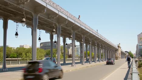 Pont-de-Bir-Hakeim-bridge-with-metallic-pillar-and-road-in-Paris,-France