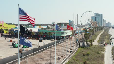 American,-South-Carolina,-Navy,-Marine-Corp,-Army-flags-at-Boardwalk-Promenade-at-oceanfront,-Myrtle-Beach,-SC-USA