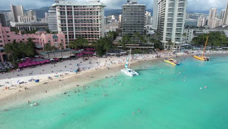 A-drone-rotates-showing-an-aerial-view-of-a-tropical-island-beach