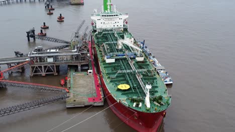Silver-Rotterdam-oil-petrochemical-shipping-tanker-loading-at-Tranmere-terminal-Liverpool-aerial-view-slow-push-in
