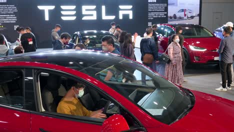 A-buyer-sits-and-tests-an-American-EV-electric-company-car-Tesla-Motors-car,-Tesla-Model-Y,-during-the-International-Motor-Expo-in-Hong-Kong