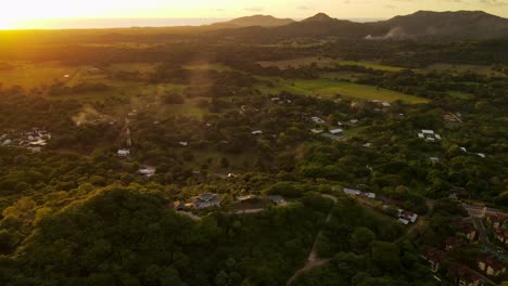 Cinematic-aerial-footage-of-a-pompous-mansion-on-a-hill-within-the-rainforest