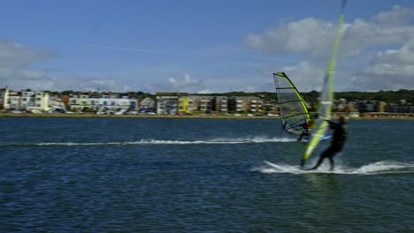 Water-sports-activity-Windsurfers-in-slow-motion-pass-each-other-on-West-Kirby-marine-lake