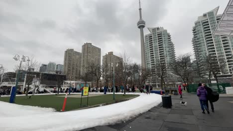 Toronto-harbour-front-water-front-skating-in-city-during-winter-with-CN-Tower-in-background---urban-city-with-people-skating