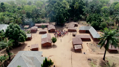 Residents-of-a-small-village-community,-Olegobidu,-Nigeria,-disburse-after-gathering-for-a-drone-video