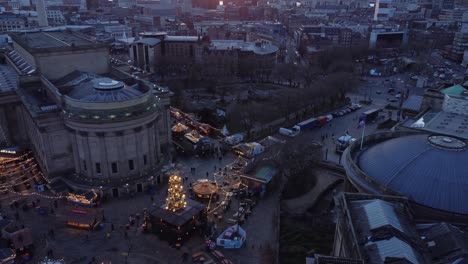 Liverpool-city-Christmas-market-2021-winter-attraction-aerial-view-tilt-up-to-sunset-skyline