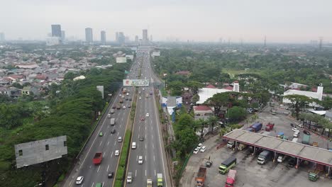 aerial-shot,-heavy-freeway-traffic-with-trees-around