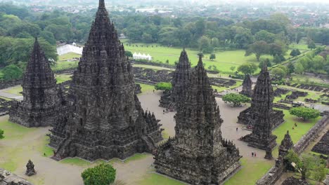 Prambanan-Hindu-temple-in-Yogyakarta,-Indonesia-during-rainy-season,-Aerial-pedestal-rising-shot
