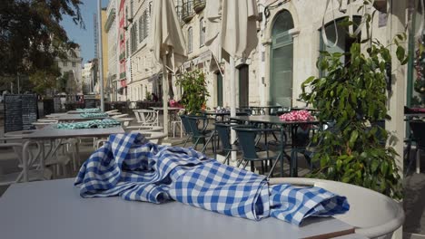 Close-Up-Of-Blue-White-Cheque-Cloth-On-Table-Outside-Restaurant-In-Lisbon