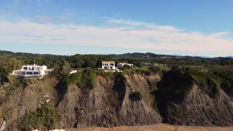 Breathtaking-daytime-aerial-drone-flight-offshore-coastline-waves-to-a-luxury-villa-on-a-malibu-cliff