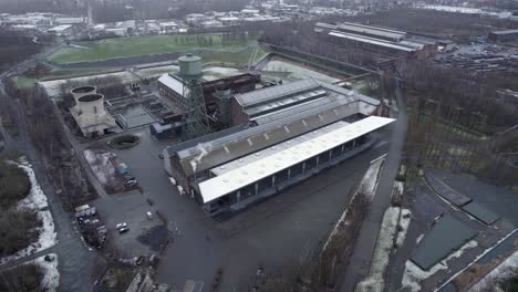 Snow-falling-over-Westpark,-industrial-park,Drone-aerial,-Bochum