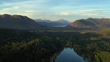 Lush-Forest-Scenery-and-Magnificent-Mountain-Range,-over-montana-lake,-USA---aerial-shot