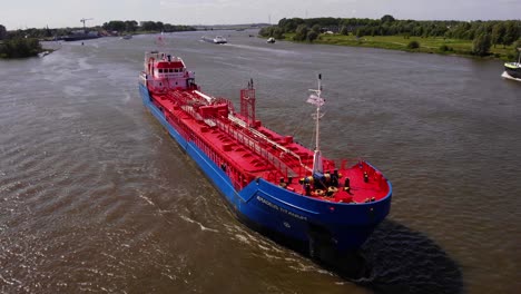 Aerial-View-Of-Amadeus-Titanium-Chemical-Tanker-Travelling-Along-Oude-Maas-On-Sunny-Day
