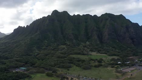 Wide-aerial-dolly-shot-of-a-picturesque-volcanic-mountain-ridge-above-Kualoa-Ranch-on-the-island-of-O'ahu,-Hawaii