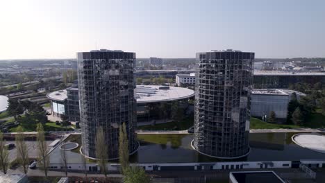 backwards-aerial-from-the-2-Turmfahrt-towers-in-Autostadt-in-Woflsburg,-Volkswagen