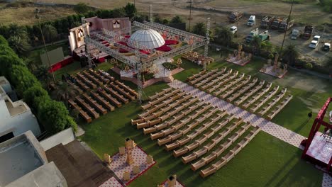 footage-of-spacious-event-location-by-the-water,-big-white-dome-in-center,-organized-chair-set-up-on-the-large-evergreen-lawns,-colorful-vibes,-bright-outdoor-day,-event-space-for-several,-day-shot