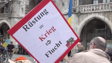 A-person-holding-a-sign-in-German-during-an-anti-war-demonstration-in-Munich,-Bavaria,-Germany